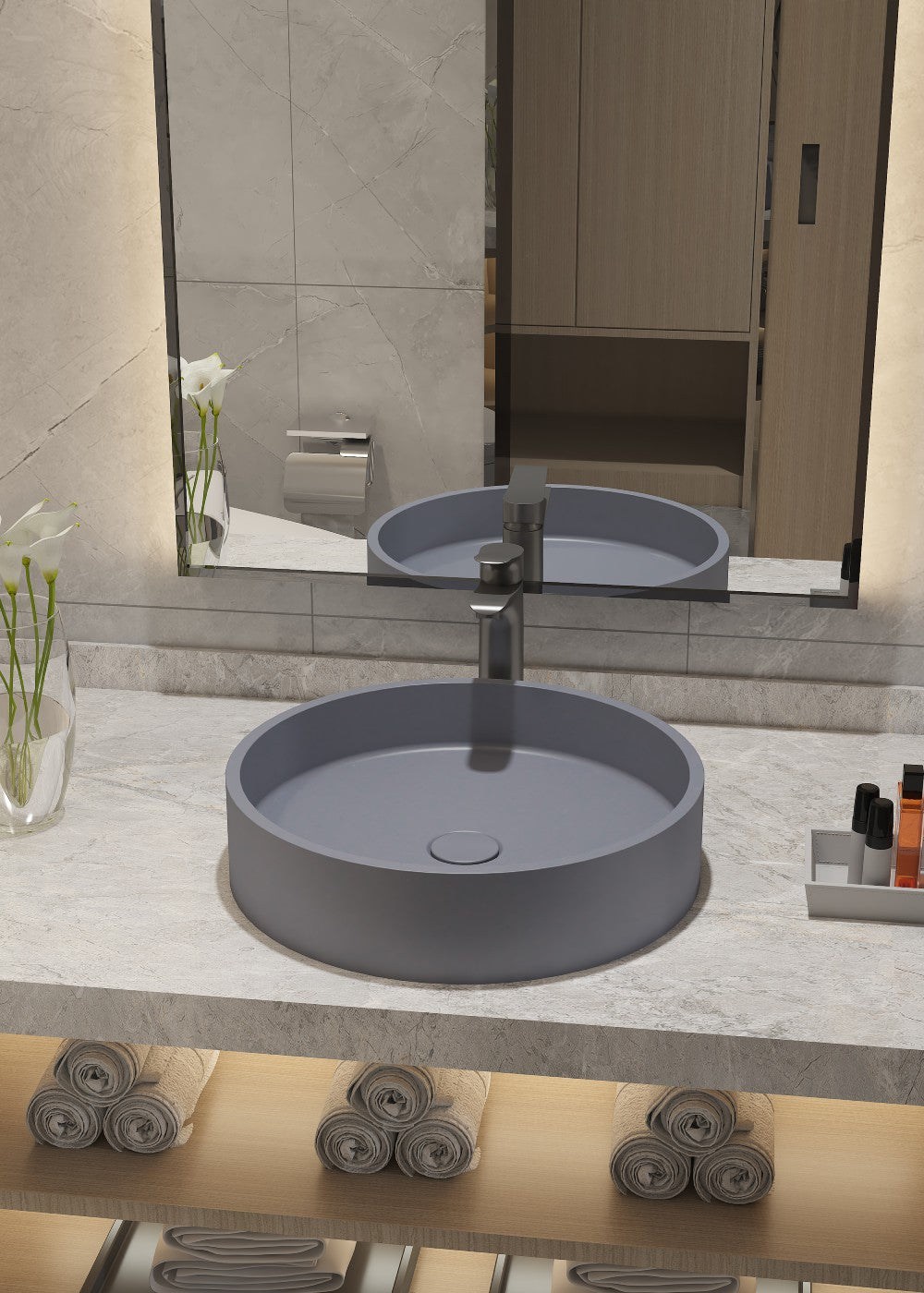 Bathroom vanity with two round gray sinks, mirror, and toiletries.